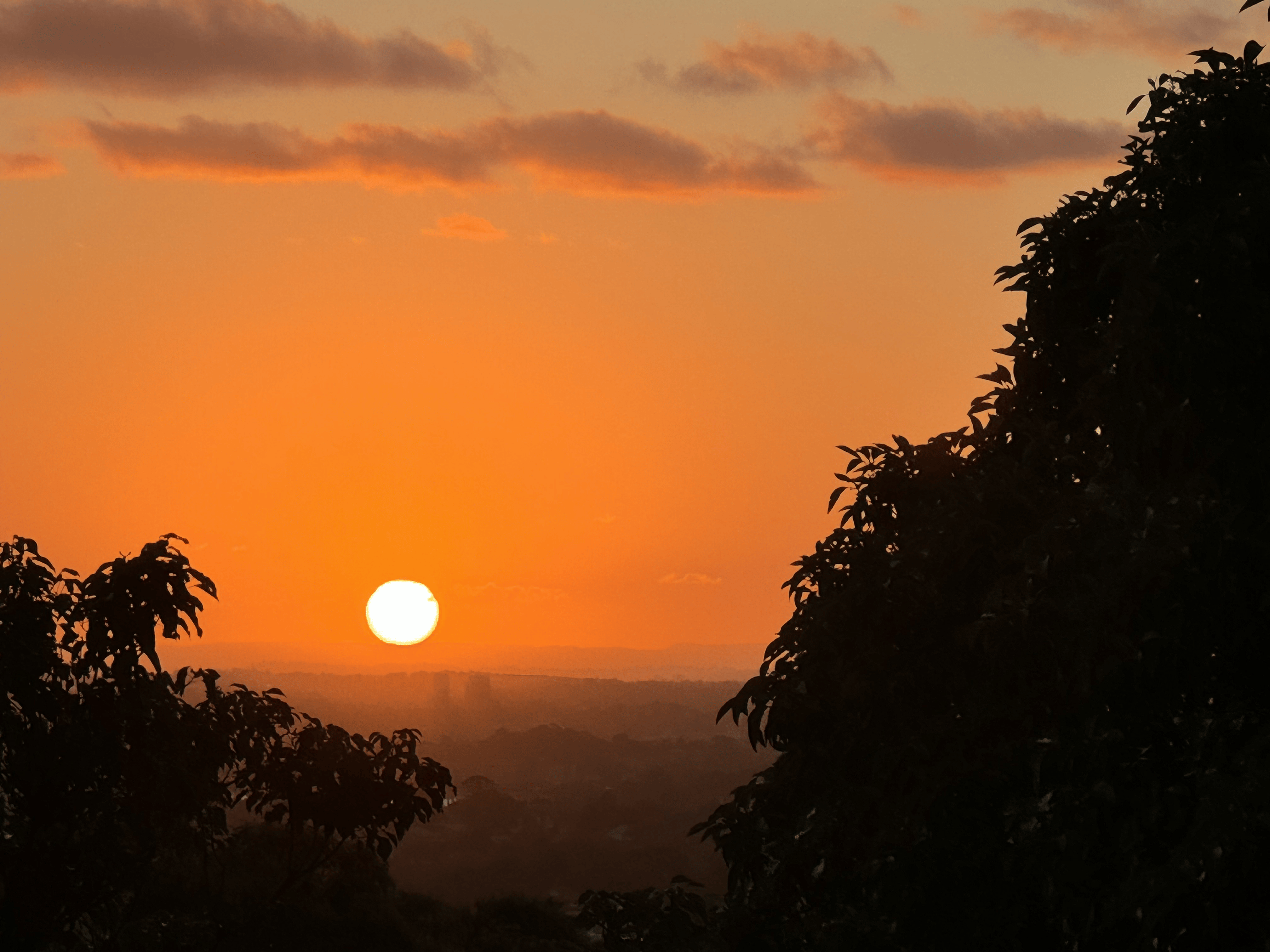 Melissa Movafaghi - Contego Media - Sunset Touching Mountain Horizon Over Sydney - Dark Orange Sky - Photograph Credit Melissa Movafaghi